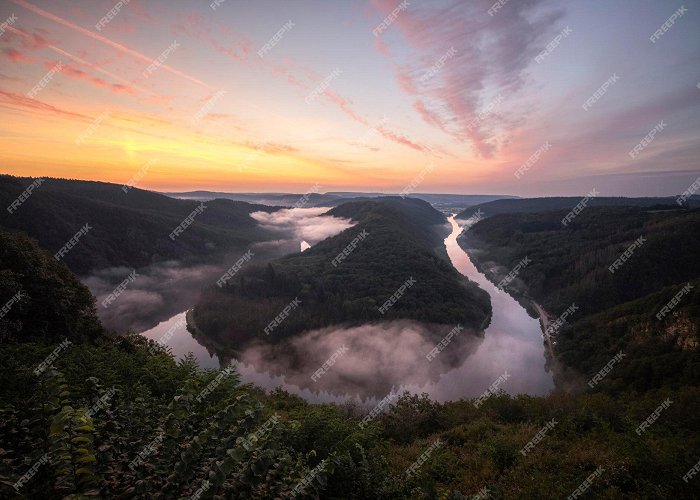 Saarschleife Premium Photo | Majestic sunrise and foggy landscape at ... photo